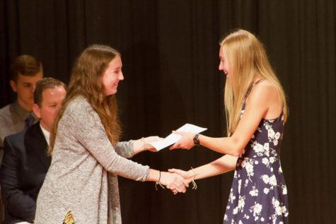 NHS Vice President Katie Saluk awards new-inductee Maddie Botos her certificate. The Crush-O-Gram activity is put on by Atlantic's NHS chapter.
