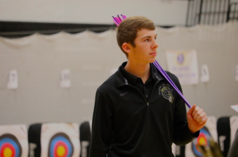 Sophomore Cooper Jipsen carries his arrows at this season's home tournament. Jipsen shot a 296 at the Creston tournament this past weekend.