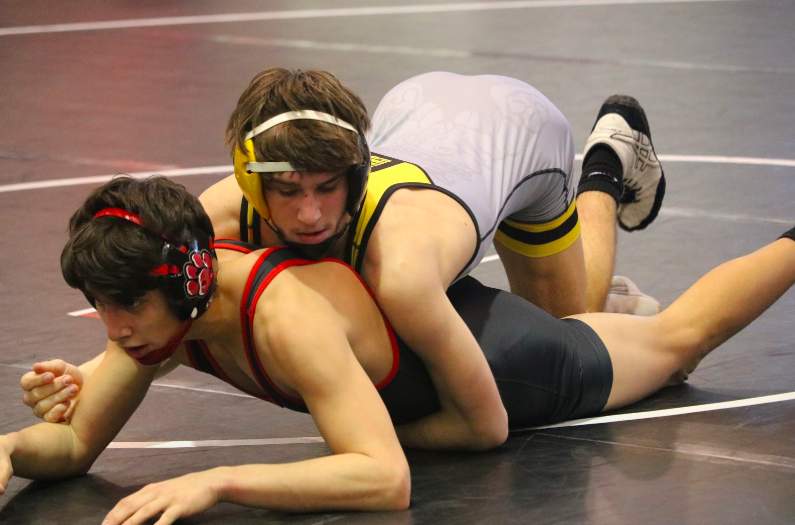 Junior Joe Weaver holds his opponent to the mat moments before securing his first place win and advancing to Districts.