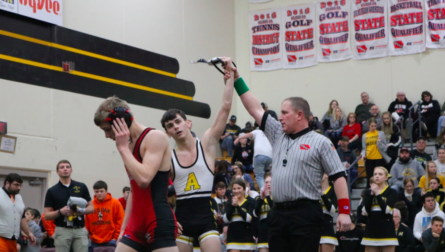 Senior Aybren Moore raises his arm in triumph. Moore qualified for State in the 113 pound weight class. 