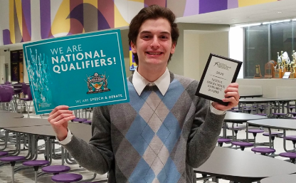 Junior Troy Roach poses with his plaque after qualifying for the National speech and debate tournament. Roach attended the tournament last year along with 2019 grad Sarah Schorle and junior Genevieve Martinez.