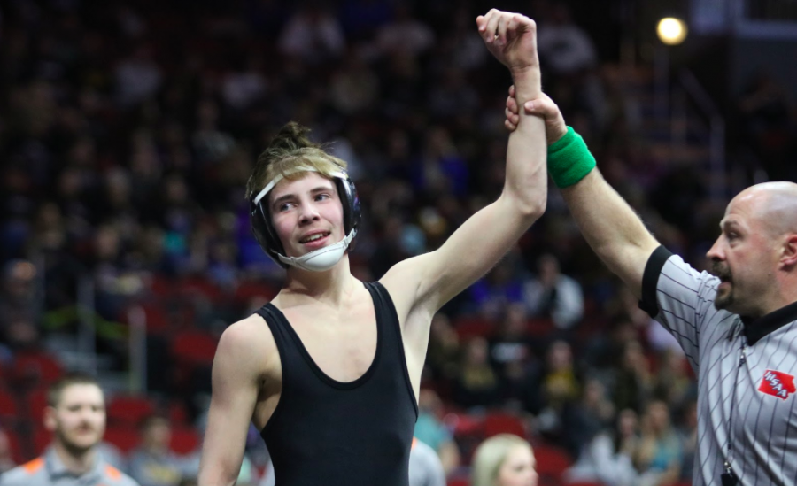 Freshman Easton O'Brien raises his hand after winning his first match, 8-7. O'Brien went 1-2 for his first year at the State tournament.