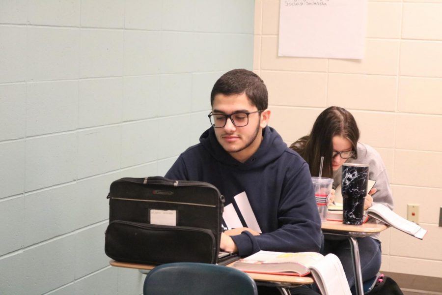 Junior Ricardo Queiroz da Cunha gets to work during his first period psych class. This is his first time in the United States.