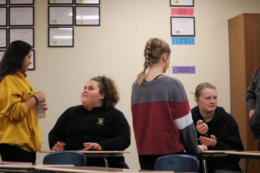 A group of freshmen work together during Drama class. Speech coach Alex Bales teaches the course.