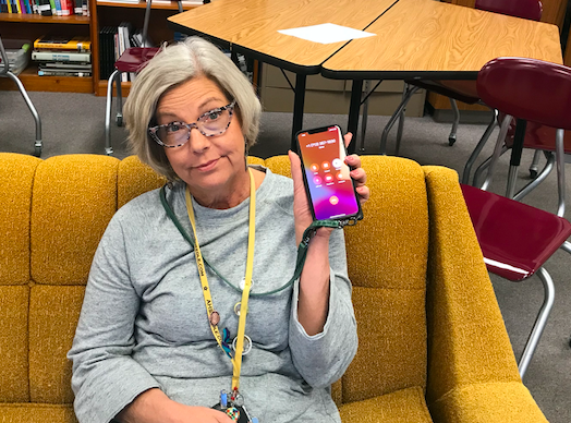 Adviser Allison Berryhill showcases yet another spam phone call during class. Callers can spoof phone numbers to appear like they are coming from in town.