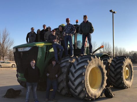 The ten boys who participated in Tractor Day pose with one of their sick rides. Tractor Day is an annual event.