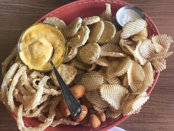 The appetizer plate at Weitzels contained potato chips, cheese balls, onion rings, fried pickles, cheddar and regular ranch. The price point for this platter is $12.25.