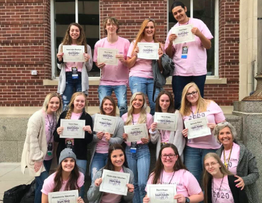 The AHS journalism team holds up their awards at the 2019 IHSPA fall conference. Awards are announced in the spring and then distributed in the fall.