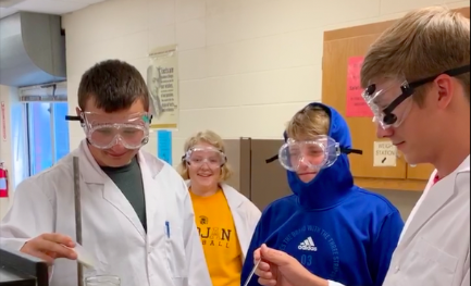 Juniors Gunner Kirchhoff, Molly McFadden, Drey Newell, and Skyler Handlos preform an experiment. The students were assigned to create a video explaining different reactions.