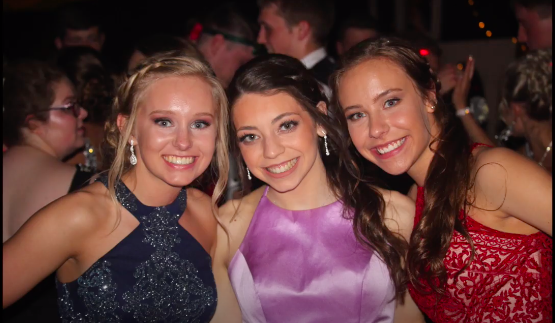 Three seniors pose for a picture at last years prom. Prom 2020 is themed The Roaring 20s.