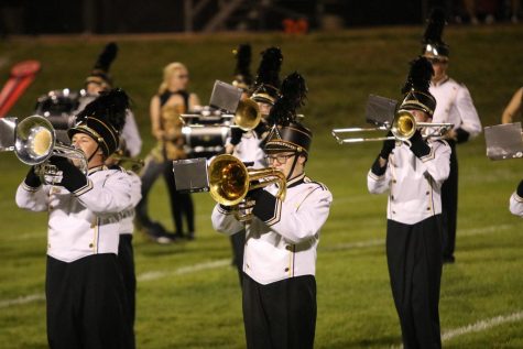 The trumpets play along with the Trojan Guard during the Trojans game against Harlan last year. This year the Trojan Guard has 20 senior members.
