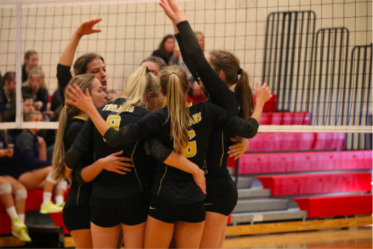 The varsity team huddles together after a victory. The girls had a winning streak of 3-0. 