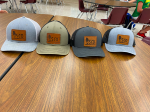Senior Gunner Kirchhoff shows off some of Shroom Crew Outdoors merchandise. Selling hats is one way for the brand to get advertisement and make money.
