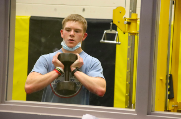 KEEP YOUR DISTANCE! Lifting with a mask on can be difficult at times.  This is why social distancing in the weight room is important. For Senior Craig Becker said wearing a mask is worth it if he still gets to play his sports. 