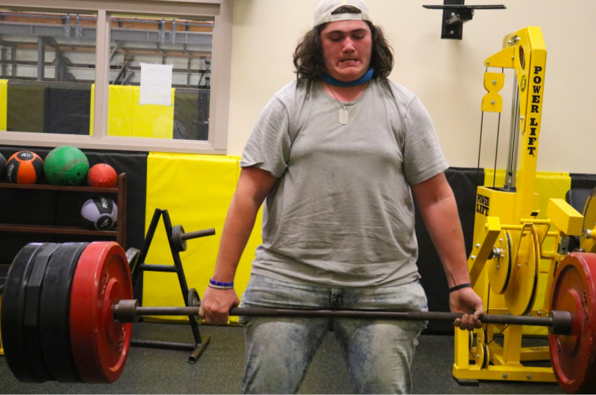 HARD WORK PAYS OFF - Senior Zach Colton deadlifts and works hard to get to his max. Colton played football all four years of high school. Lifting was a big part of gaining muscle for the season. 