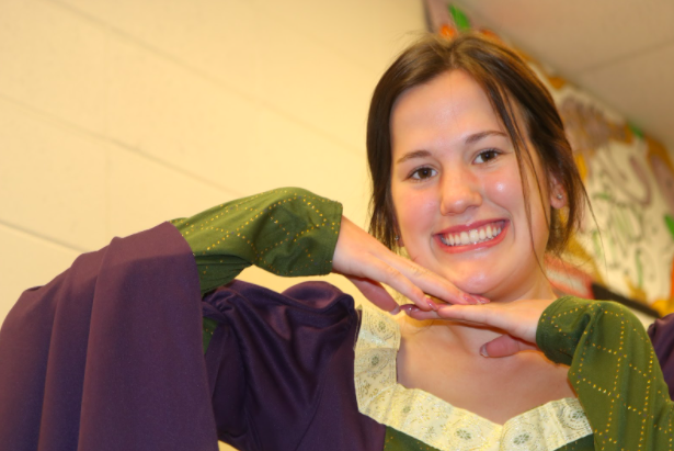 Senior Anna Weiser smiles in her historical attire. Weiser was on the royal court during the Madrigal.