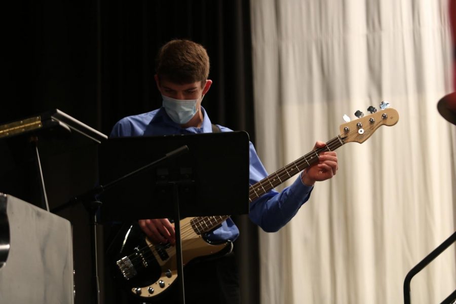 Senior Ethan Williams focuses on his music as he play bass at Swing Inn. Williams is also involved in cross country, basketball, tennis, musical pit, and marching and concert band.