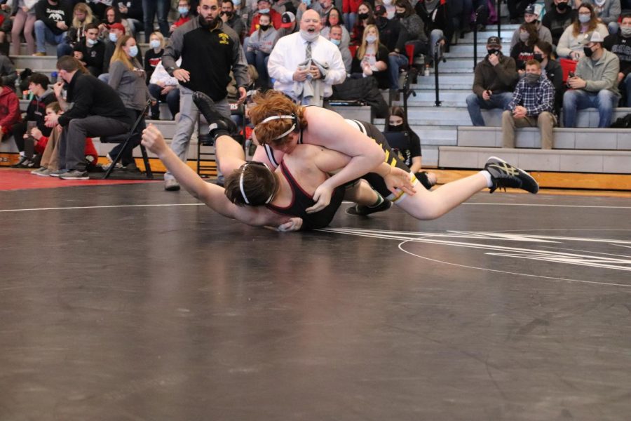 BIG THROW - Sophomore Tristan Dorscher upsets the number one seed with a huge throw and pin. Dorscher advanced tot he State tournament for the first time in his young career.