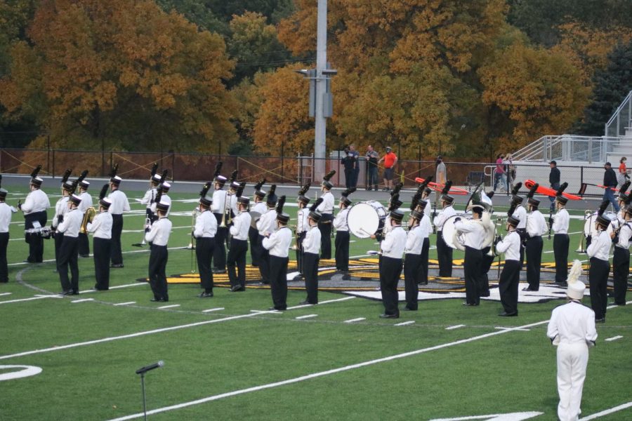 The Trojan Guard, the marching band of AHS, marches onto the field during the 2020 homecoming game. Many band members will be among the 85 musicians traveling to Orlando to preform in Universal Studios.