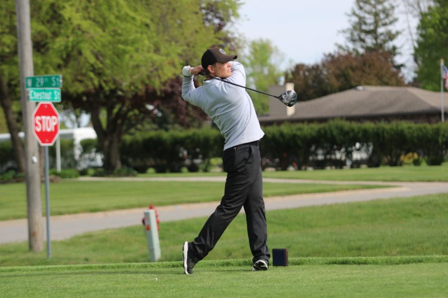 Junior Lane Nelson preps for a swing at a home match. At the Hawkeye Ten Championship, Nelson placed 7th individually with a score of 80. 