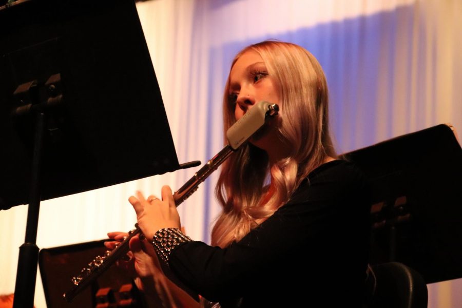 Junior Jaci Smith closely follows her music at the Late Winter Concert earlier this year. Smith has been in band and choir all throughout high school and plays the flute.