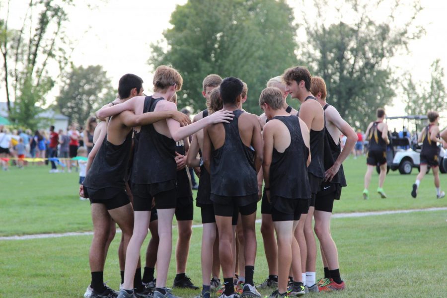The+Cross+Country+team++embraces+before+the+Ballard+meet+on+September+13.+
