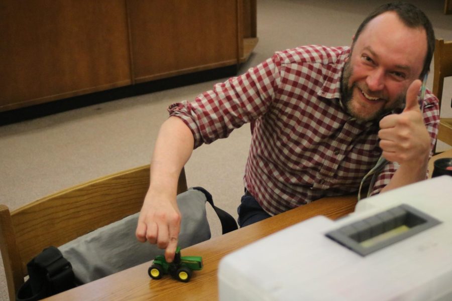 English teacher Randall Simpson plays with a tractor given to him by his students.