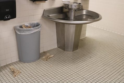 Trash litters the floor of the restroom in the commons. This is the most commonly used restroom in AHS, but also most trashed.