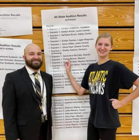 Genevieve McCalla shows off her All-State acceptance with choir director, Evan Adamon. She joined the choir shortly after moving to Atlantic because she enjoyed making new friends in that class.