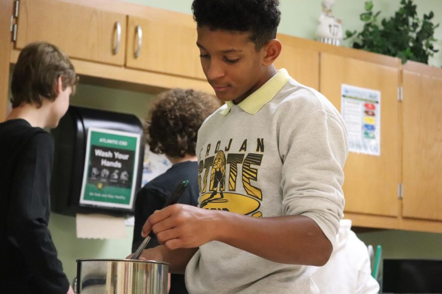 STIRRING UP THE COMPETITION - Sophomore Dante Hedrington stirs pudding in Foods 1. Hendrington has a passion for baking. He helps with his familys baking business.