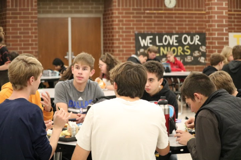 Sophomore Brock Henderson and friends are eating the provided school lunch.
