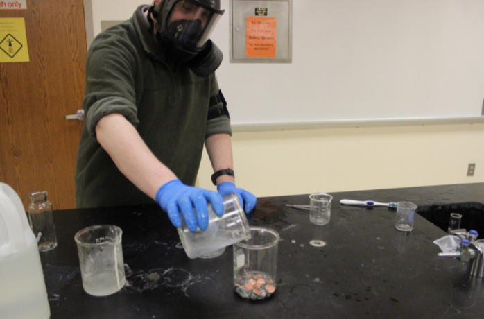 Mr. Todd sets up the penny experiment for the last time of the day. Before placed over a beaker, the pennies floated in their solution. Each student was told to bring a penny minted in 1984 or before. 
