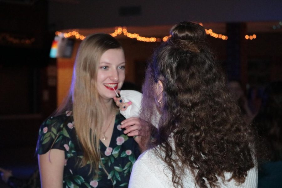 CHEESIN- Sophomores Genevieve McCalla and Neveah Duranceau talk during the winter formal dance.  Perfoming together in choir, the both have been friends throughout high school.