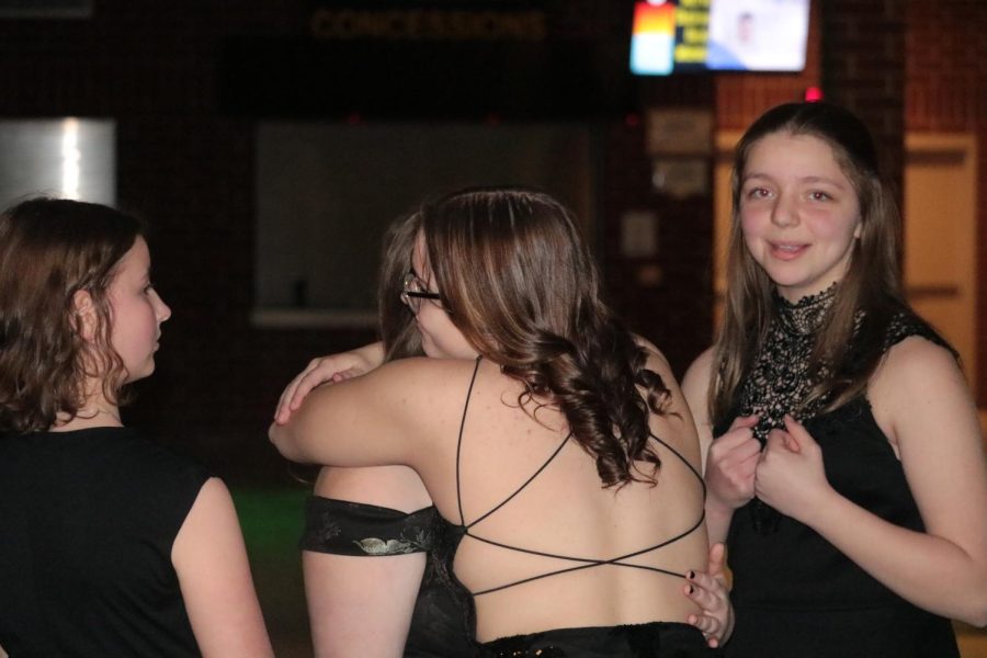 LAST YEAR- Senior Kayla Mendenhall hugs someone. This is her last year dancing at Winter Formal and she had a really fun time. She danced with her friends, including freshman Brianna Atkins. (pictured)