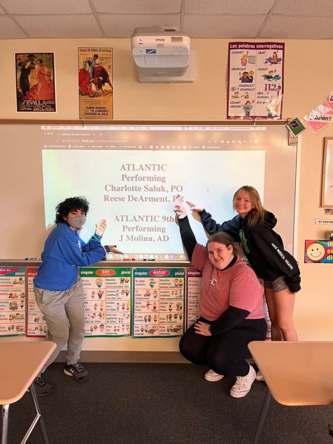 Freshmen J. Molina and Juniors Charlotte Saluk and Reese DeArment pose beside the All-State acceptance list. The list was posted on Monday, March 14. High school students across the state were looking forward to the posting.