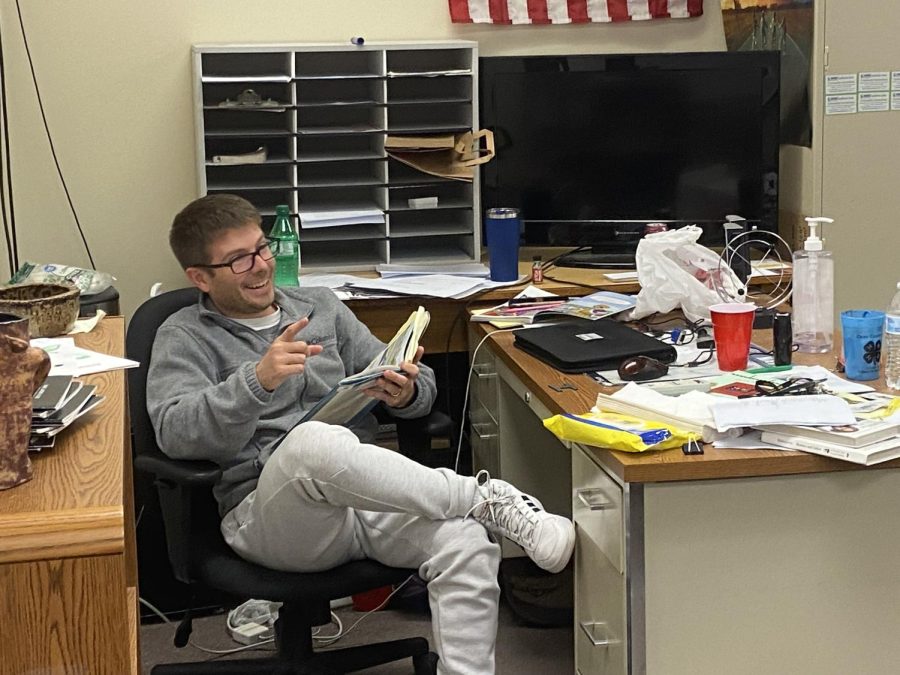 Brandon Baggett sits in his classroom reading aloud to the class. 