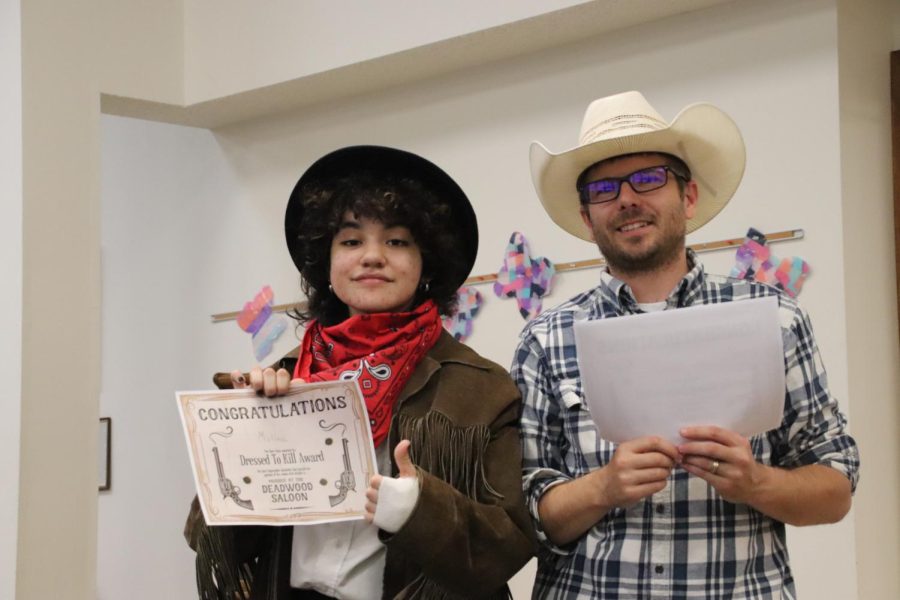 J. Molina and Mr. Baggett pose for the Dressed to Kill award. Molina was awarded this for having the best costume out of those at the Murder Mystery Dinner. 