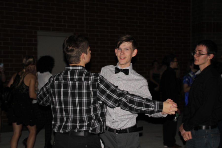 KEEP THE PARTY GOING -- Sophomores Kyeden Dorscher and Garrett VanHorn dance with each other outside of the schools front doors. Although the school had been evacuated and there was no music, students continued to have fun and party on the sidewalk.