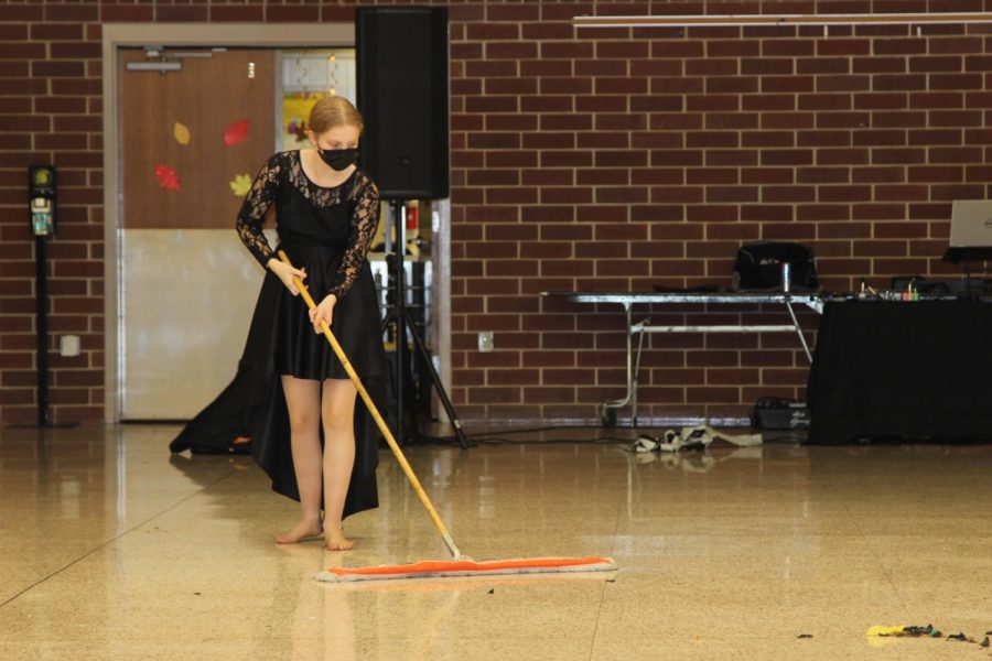 WHISTLE WHILE YOU WORK -- Sophomore Nissa Molgaard sweeps the popped balloons off the floor after the dances completion. Student council members and their friends remained after other students had left to clean up the balloons and streamers in preparation for school on Monday.