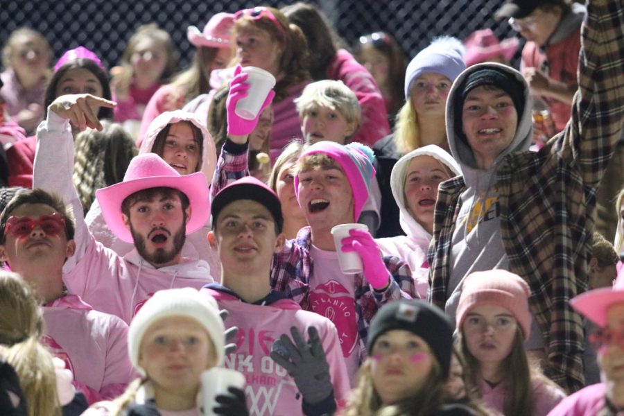 PRETTY IN PINK-
AHS Students crowd into the student section for a football game. Every year, Atlantic hosted a pink out game to honor individuals who were battling breast cancer. At the game. students threw pink smoke bombs and confetti after every touchdown.