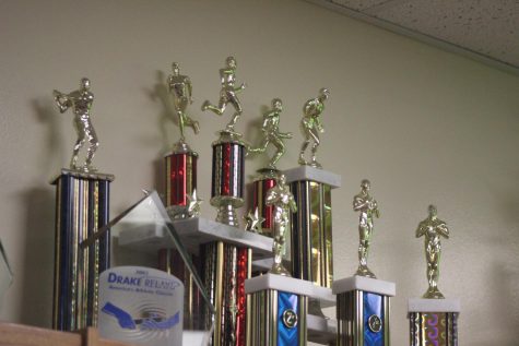 Many dusty trophies line the crammed shelves of the library.
