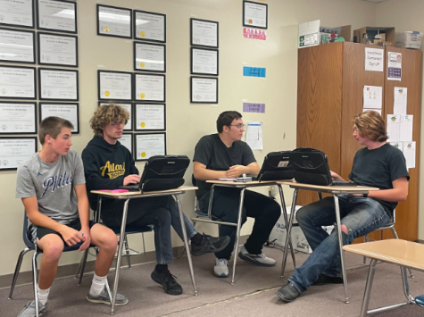 Freshmen Sawyer Tarrell accompanies seniors Weston Hoover, Merrick ODette, and Ty Ostrus at a debate meeting.