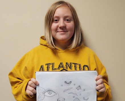 Molly Harris displays her sketch for the mural she hopes to paint in downtown Atlantic. The project is part of her 100 hours of community work for Girl Scouts. 