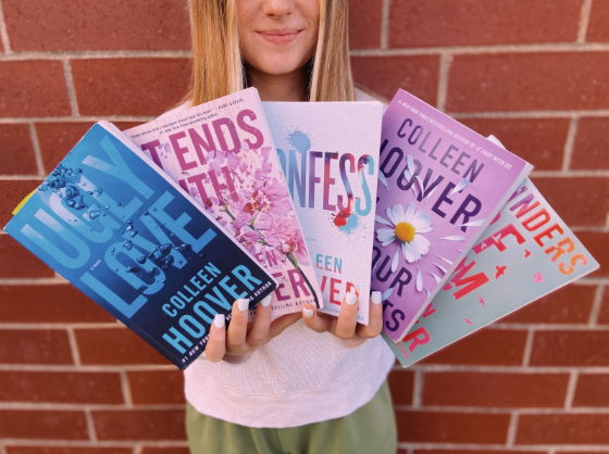 An AHS sophomore shows her love of Colleen Hoover books.
