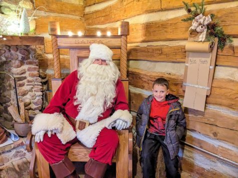 Jase Oswalt, a toothless second grader from Washington Elementary, asks Santa Claus (Andersen) for his two front teeth for Christmas this year. The Gingery Log Cabin creates the perfect cozy space for Santa to come to visit during the winter months.