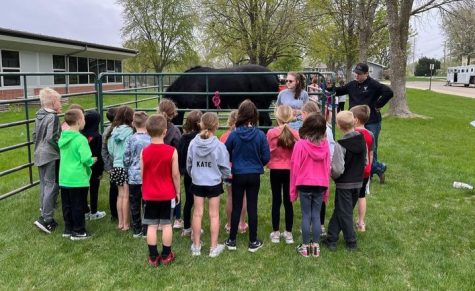 Charli Goff and Colton Becker teach kids about draft horses. The kids had the opportunity to pet the horse and hold a horseshoe.