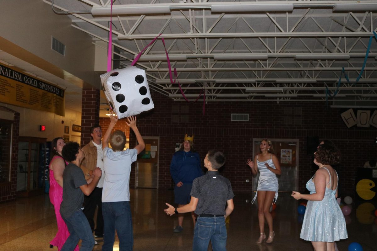 DICE GAMES - Students join together at Homecoming dance to hit around the three giant dice which were available. The dice were deflated by the end of the night.