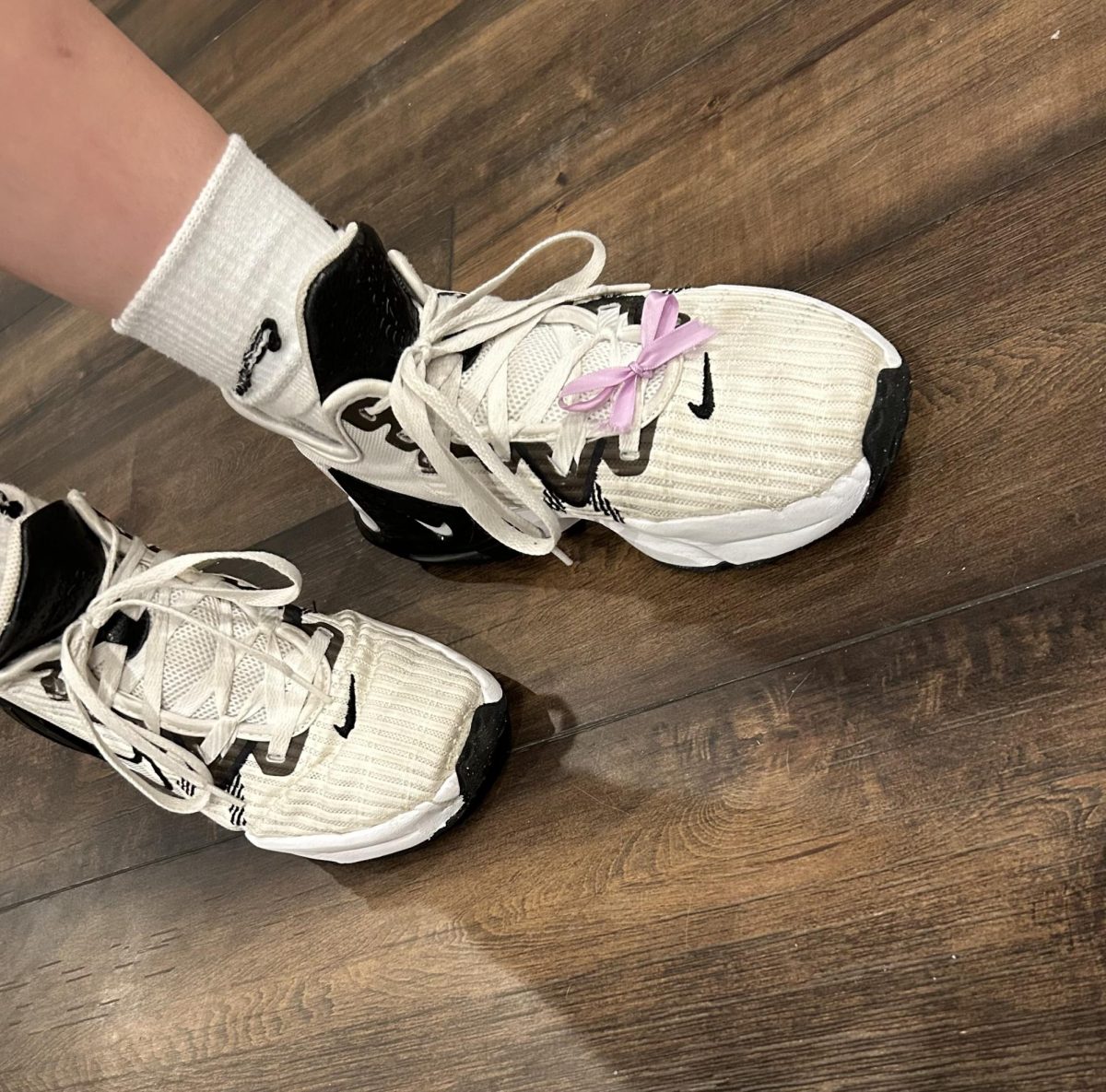 Claire+Schroder+wears+a+ribbon+on+her+volleyball+shoe+to+honor+her+dads+friend+that+died+from+pancreatic+cancer.+Many+people+wear+small+clothing+items+to+show+their+support+daily.