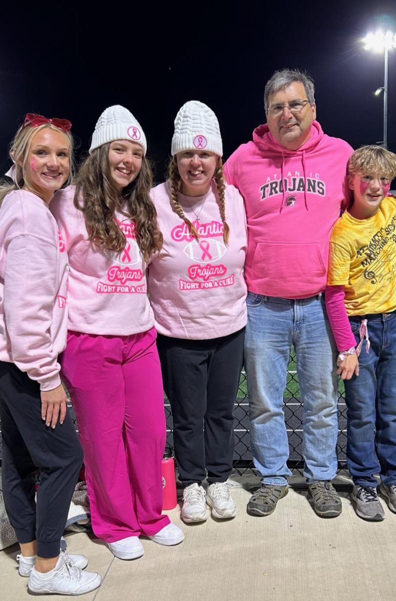 Kyra Rink, Alyssa Neal, and Neals family geared up for the football Pink Out game. Neals mom was recently diagnosed with breast cancer.