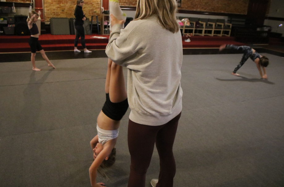 JUMP? LEAP? TUMBLE! - Dance Atlantic is the place to be, especially with freshman Payton Burg there to help out. She helped the little class with handstand tuck and rolls during tumbling class. The class performed other tricks during the class as well.